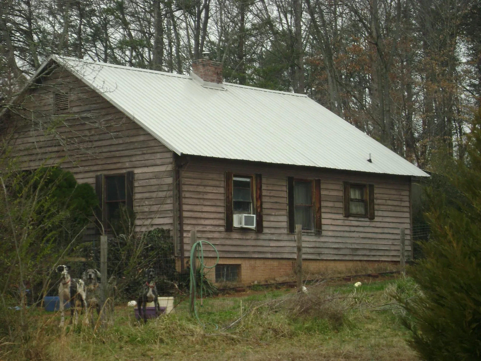 White metal roof on an old wood sided farmhouse, from a Metal Roof Installation job in Parkers Prairie